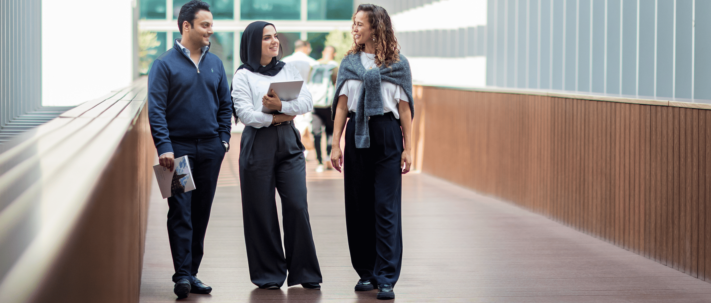 Georgetown Dubai students walking in a hallway while talking.
